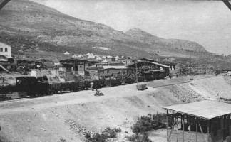 A view of a narrow gauge train, carrying troops and supplies.